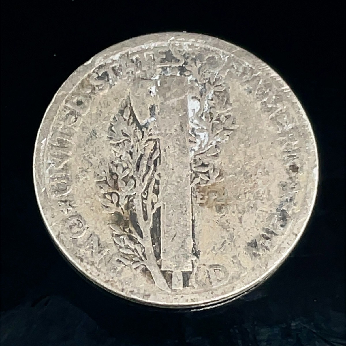 1925 Mercury dime lamination error showing surface peeling and metal separation on obverse